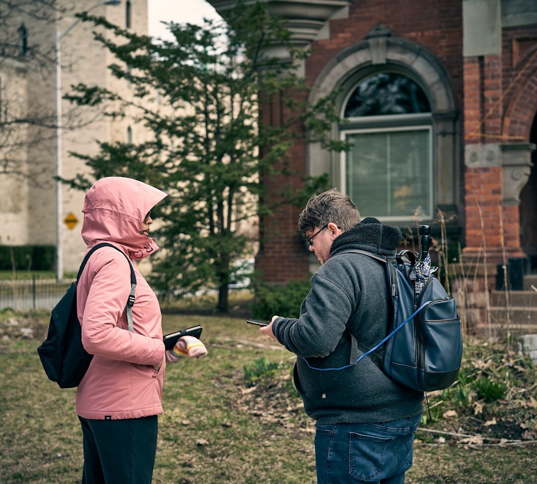 Interviewer conducting a public opinion survey with a respondent outdoors